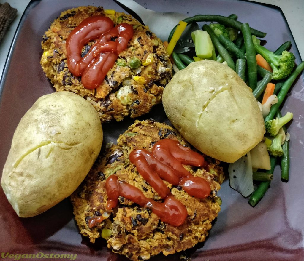 Home made bean burger patties with potatoes and veg