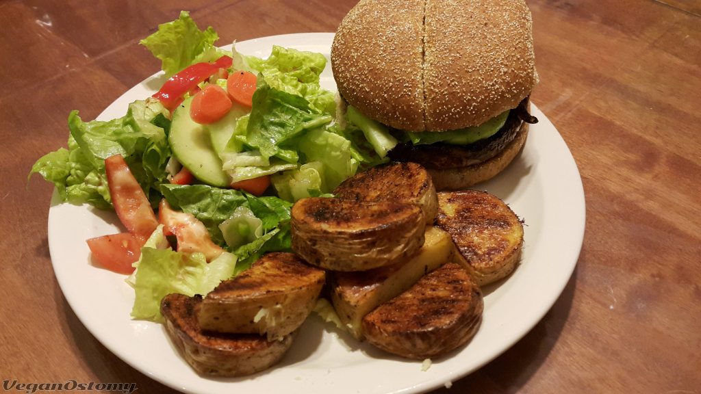 Portabello mushroom burger with roasted potatoes and a side salad
