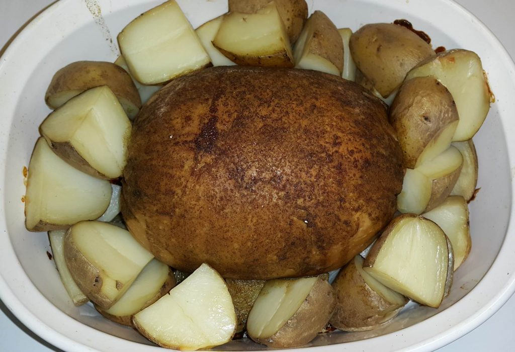 Tofurky Roast cooked with potatoes and onions